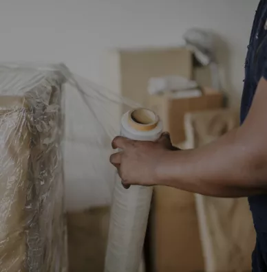 Mover wrapping a cardboard box